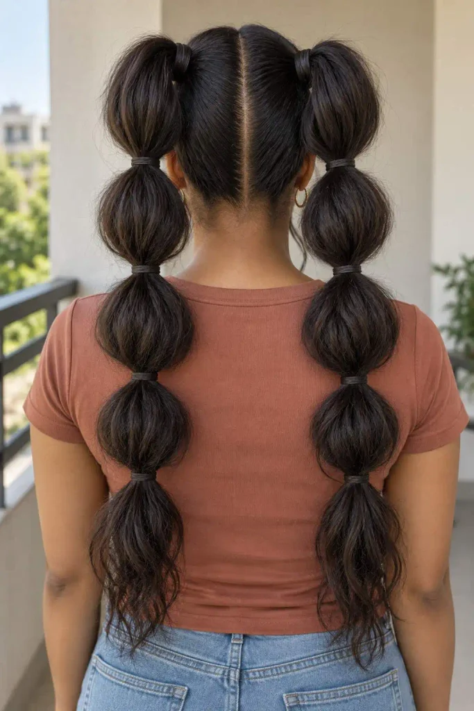 Double bubble ponytails with volume